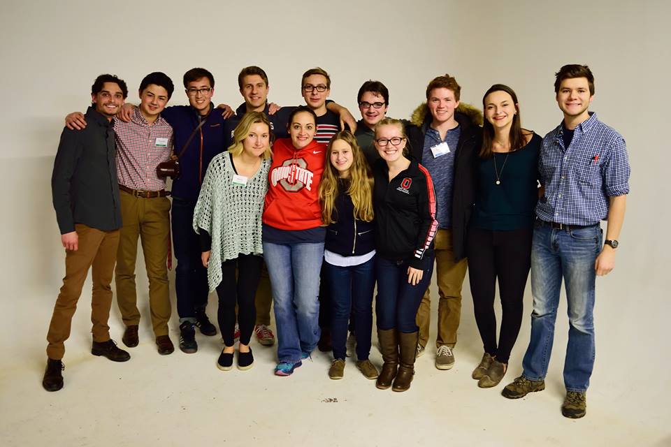 Students hug and pose