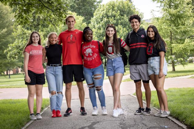 Group of students side-hugging on the oval