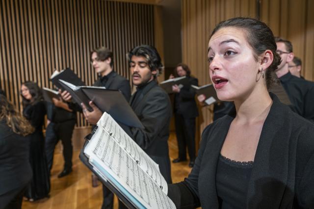 Choir singing with young woman in foreground